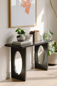 a black table with some books and plants on it