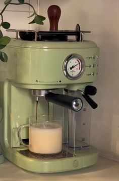 an espresso machine with milk being poured into it