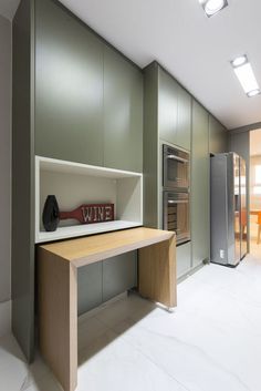 a kitchen area with a counter, refrigerator and oven in it's center wall