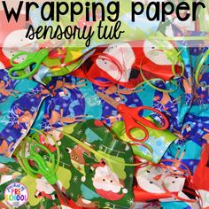 a pile of wrapping paper with scissors and santa clause on it in front of the title