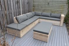 a wooden couch sitting on top of a wooden deck