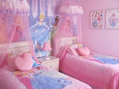 two beds in a room with pink walls and curtains on the ceiling, one has a princess doll