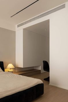 a bedroom with white walls and black furniture