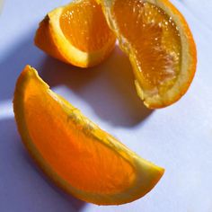 an orange cut in half sitting on top of a table