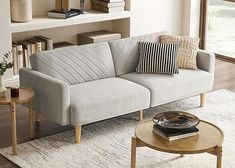 a living room with a couch, table and bookshelf in the back ground