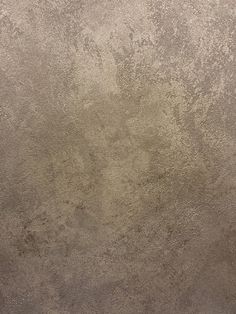 an image of a grungy concrete wall textured with light brown paint or cement