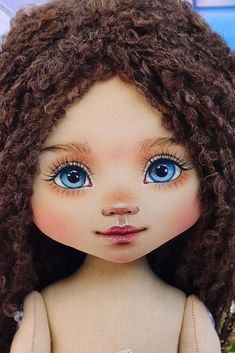 a close up of a doll with blue eyes