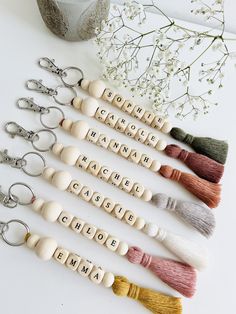 six wooden key chains with name charms on them