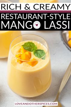 two glasses filled with mango lassa and topped with minty garnishments