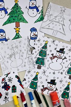 snowmen and christmas trees are on the table with crayons, markers and paper