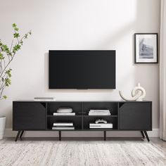 a flat screen tv mounted to the side of a wooden entertainment center in a living room