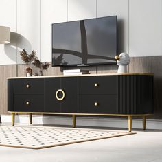 a black and gold sideboard in front of a flat screen tv