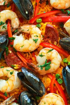 seafood and rice dish with shrimp, mussels, carrots, bell peppers and parsley