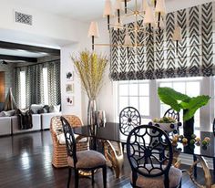 a living room filled with lots of furniture and decor on top of a hard wood floor