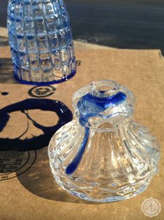 two glass vases sitting on top of a cardboard box