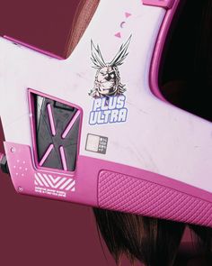 a close up of a pink and white helmet with an anime character on it's face