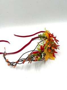 Celebrate the essence of fall with our Autumn Wedding Flower Crown. This handcrafted bridal accessory beautifully merges red and yellow autumn leaves with delicate flowers, creating a picturesque headband that complements the warm, rustic tones of fall. Whether you're a bride embracing the season on your special day, or simply looking to bring the magic of autumn to any outfit, this flower crown is sure to enchant. The versatile design makes it suitable for both adults and girls, making it a charming choice for weddings, photo shoots, or everyday whimsy. Don this Flower Crown Headband and let the autumnal romance take over. Wedding Floral Headpiece, Groomsmen Buttonholes, Floral Headpiece Wedding, Headpiece Flower, Wedding Flower Crown, Yellow Autumn, Leaves Headband, Flower Crown Headband, Bridal Accessory