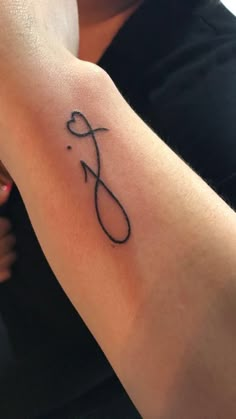 a woman's arm with a tattoo on it that has an infinite sign in the middle