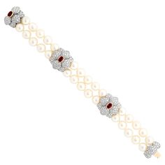 A Tiffany & Co. platinum bracelet, adorned with two rows of lustrous pearls and three delicate diamond flowers, each boasting a captivating ruby center. 30 pearls ~8.75-8.80mm 3 oval rubies ~1.80 total carat weight round diamonds ~6.50 total carat weight; F-G color and VS clarity Signed "Tiffany & Co. PT950 FRANCE" 41.71 DWT Pearl Jewelry Tiffany & Co., Pearl Bracelets Tiffany & Co., Freshwater Pearl Jewelry Tiffany & Co., Tiffney And Co Jewelry, Pearl Diamond Bracelet, High Jewelry Bracelet, Ruby Flower, Tiffany And Co Bracelet, Platinum Bracelet