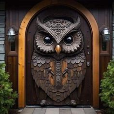 an owl statue is on the front door of a house