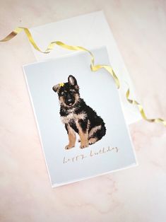 a card with a photo of a dog on it and a yellow ribbon around it