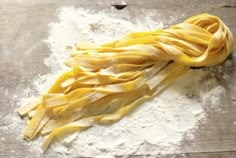 pasta on a wooden table with flour