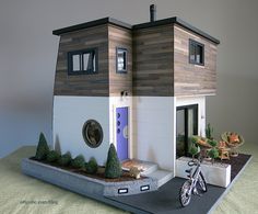 a model house with a bicycle parked next to it