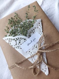 an envelope wrapped in brown paper and tied with twine