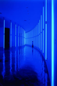 an empty hallway with blue lights and no people