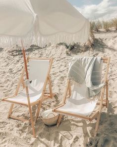 two chairs and an umbrella on the beach