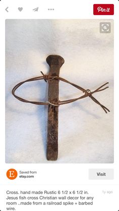 an old wooden cross with a cord attached to it