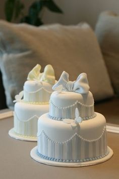 two white cakes sitting on top of a table next to each other in front of a couch