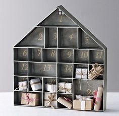 a house shaped storage unit filled with gifts and wrapped presents for the holidays or new year