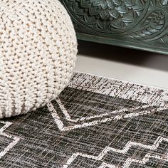 a white ball sitting on top of a rug