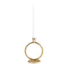 a gold candle holder with a single white candle in the middle and a ring on top