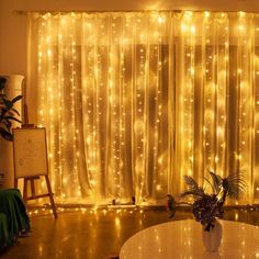 a living room filled with lots of lights next to a window covered in sheer curtains