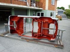 an orange car is parked in front of a building