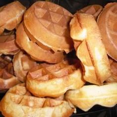 a pile of waffles stacked on top of each other in a black bowl