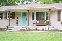 a white house with blue front door and green shutters