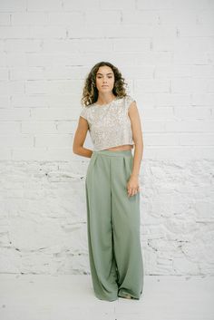 GREEN BELL BOTTOMS SET WITH SEQUINED TOP Step out in style with this classy outfit that combines elegance and sparkle for an unforgettable look. The short-sleeved top, crafted from silver sequin fabric, features a round neckline and a closed back with a delicate button closure. The palazzo pants in a soft green hue are long and wide-legged, adding a touch of sophistication and comfort. PRODUCT FEATURES:  * Set includes sequined top and palazzo pants  * Top with round neckline and open back, butt Plus Size Wide Leg Pants, Maternity Plus Size, Pants Custom, Soft Green Color, Palazzo Style, Color Composition, Sequined Top, Wide Leg Palazzo Pants, Elegant Blouses