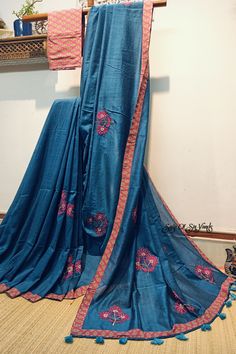 This blue handloom soft cotton saree is a true embodiment of style meeting comfort. With its beautiful floral motif embroidery, neatly done, and the addition of a printed border and tassels, it becomes a captivating and unique piece. The inclusion of both a running blouse piece and a matching cotton printed blouse piece adds further flexibility, allowing you to showcase your style effortlessly in any occasion. Details: Blouse: Yes. With matching printed cotton Blouse Piece Fabric: Handloom soft cotton saree Work: Machine Embroidery work [* This work is neither Computerized Machine Embroidery work nor machine Aari Embroidery with woolen thread. * It's completely Manual Machine Embroidery Work with silk threads..] Saree length:  6.3 mtrs Saree width: 45 inches Fall & Picot: You do not need a Cotton Blouse Piece With Multicolor Resham Embroidery, Multicolor Embroidered Cotton Blouse Piece With Resham Embroidery, Cotton Traditional Wear With Printed Border, Cotton Blouse Piece With Printed Border For Festivals, Unstitched Cotton Blouse Piece With Zari Work, Bohemian Cotton Saree For Festivals, Festive Cotton Traditional Wear With Printed Border, Bollywood Style Traditional Cotton Wear With Printed Border, Cotton Blouse Piece With Printed Border