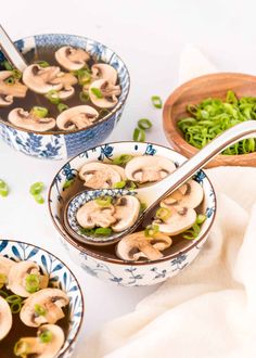 three bowls filled with mushrooms and green onions