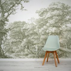 a chair sitting in front of a wall with trees on it