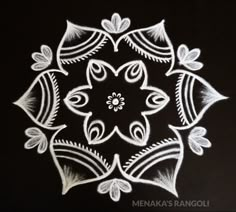 an intricate design made with white chalk on black paper