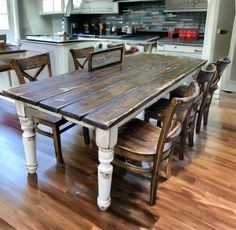 a wooden table sitting in the middle of a kitchen