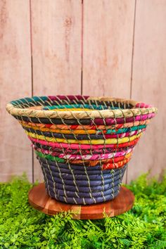 a woven basket sitting on top of green grass