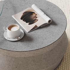 a cup of coffee and a book on a table