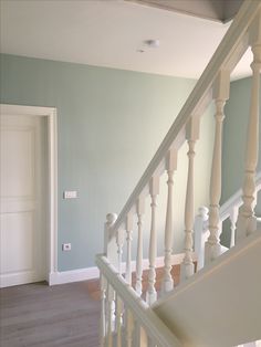 an empty room with white railings and blue walls