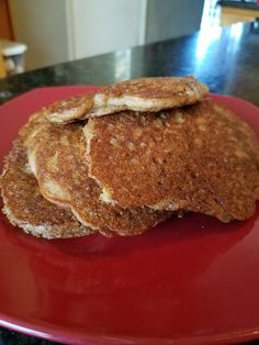 three pancakes stacked on top of each other on a red plate