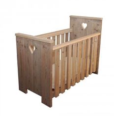 a wooden crib with heart cutouts on the sides